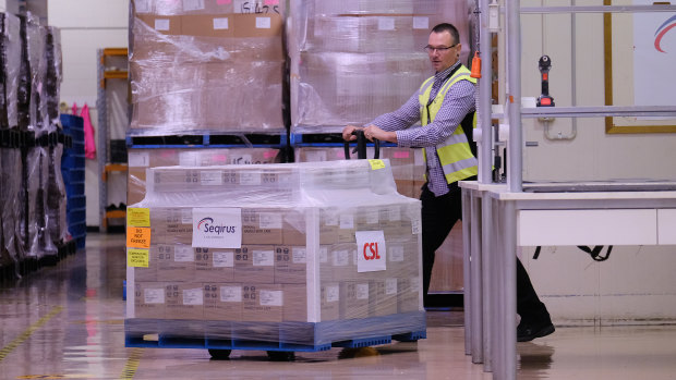 A worker rolls a batch of AstraZeneca vaccines onto a truck at a CSL factory in Melbourne. 
