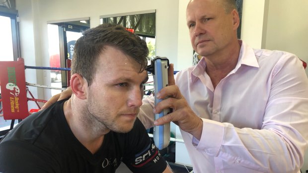 Changing the game: Noel Thornberry demonstrates the Infrascanner 2000 on boxer Jeff Horn. 