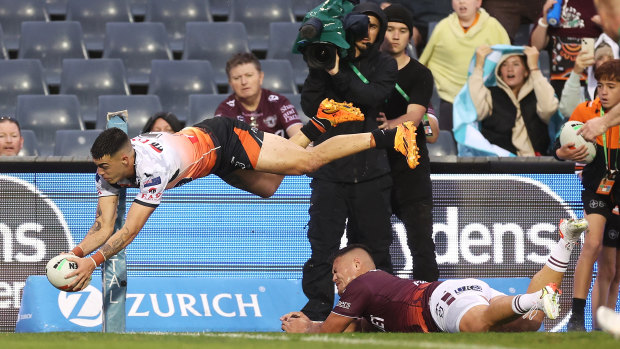 Charlie Staines scores for the Wests Tigers against Manly.