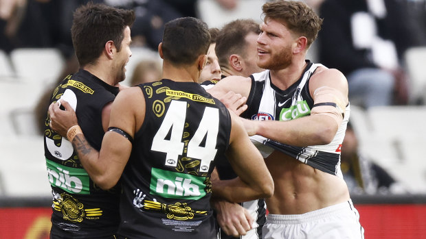 Trent Cotchin and Taylor Adams test the durability of each other’s jumpers out. 