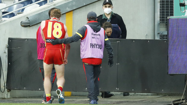 The youngster is escorted from the field.