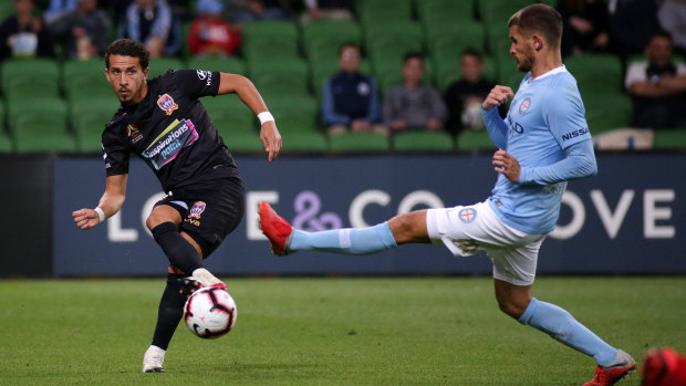 Through ball: Newcastle's Daniel Georgievski hits a pass under pressure from City's Dario Vidosic.