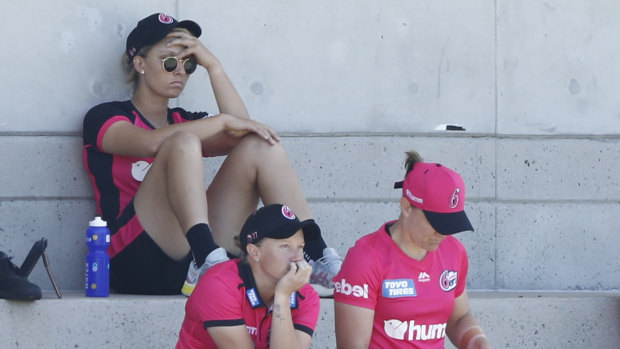 Ash Gardner nurses a sore head after being forced out of the WBBL match against Adelaide at Drummoyne Oval.