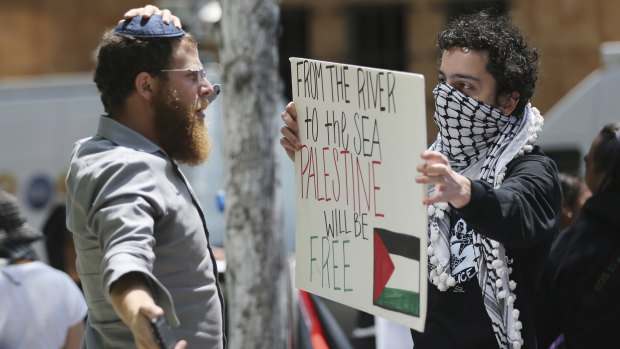 A man wearing a yarmulke, left, confronts one of about two dozen demonstrators protesting against the US embassy move on Monday.