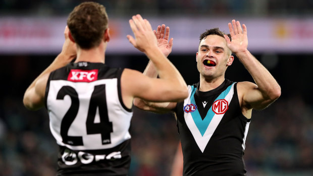 Kane Farrell celebrates a goal with teammate Karl Amon.