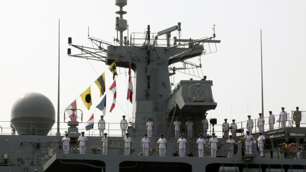 Sailors of British Royal Navy's HMS Albion amphibious assault ship man the rails upon arrival in Tokyo.