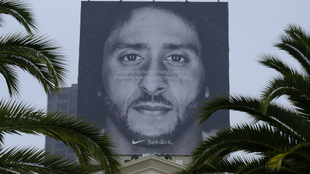 Palm trees frame a large billboard on top of a Nike store that shows former San Francisco 49ers quarterback Colin Kaepernick in San Francisco. 