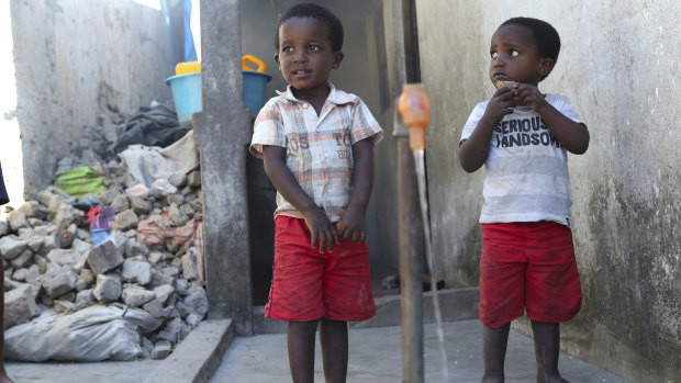 Children wait to fill up a bucket in Mozambique, where millions of people have been affected by Cyclone Idai.