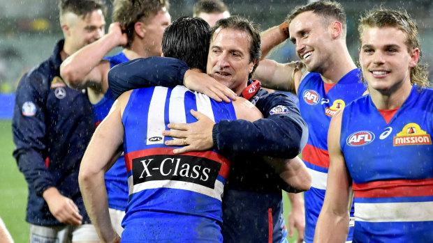 Luke Beveridge congratulates Easton Wood after the Dogs' win over the Power at Adelaide Oval in round 15.