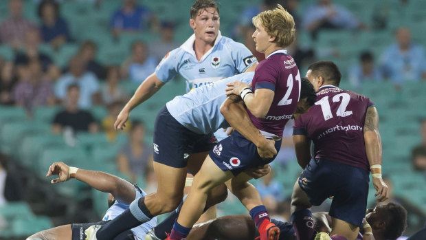 Power play: Israel Folau drives back Tate McDermott in the tackle.