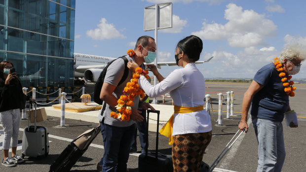 A passenger is welcomed at Denpasar airport in Bali after the resort island reopened its borders to domestic tourists on July 31.