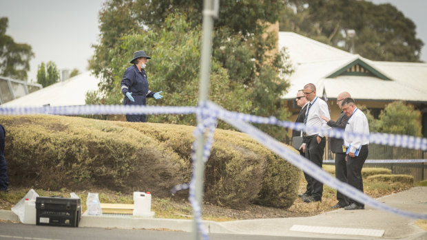 Crime scene investigators speak to senior Victoria Police at the scene where a body was found in Bundoora. 
