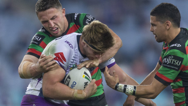 Sam Burgess of the Rabbitohs tackles Christian Welch of the Storm on Friday night.