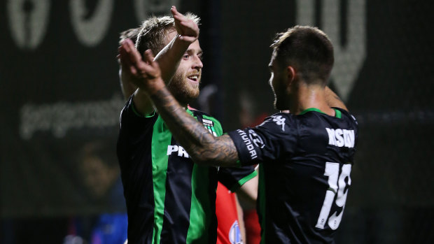 Adding to the tally: Connor Pain celebrates with teammate Josh Risdon (right) after doubling Western United's lead.