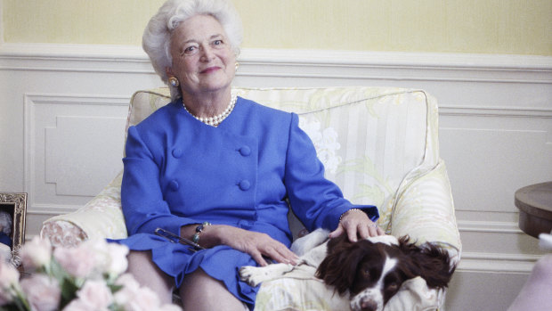 First lady Barbara Bush poses with her dog Millie in Washington in 1990.