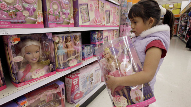 Yvette Ibarra holds a Dancing Princess Barbie doll while shopping at a toy store in Monrovia, California.