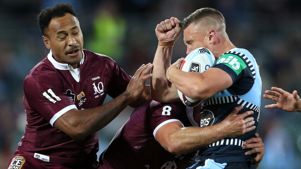 Jack Wighton (right) gets smashed by Felise Kaufusi and the Maroons defence.