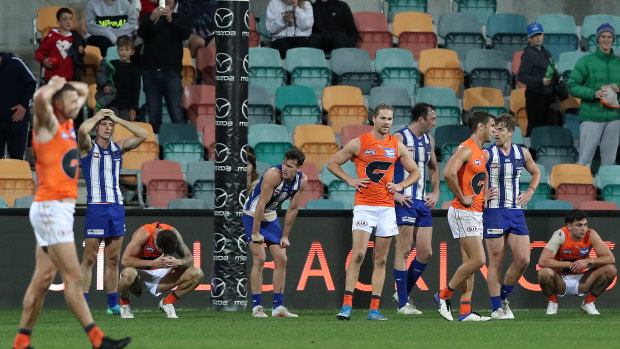 Players from both teams look dejected after the game ended in a draw.