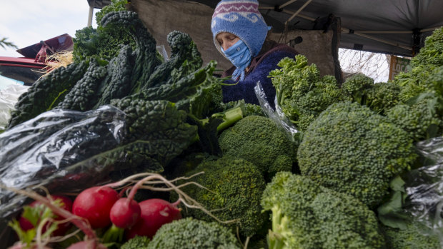 Sophia Stasey selling vegetables at the Bendigo Farmers Market. 