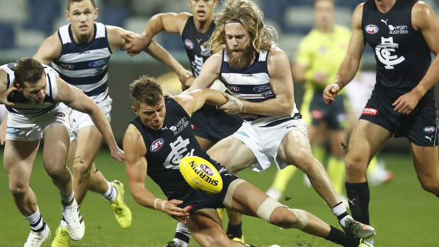 Patrick Cripps of the Blues is tackled by Cameron Guthrie of the Cats during the round 3 AFL match between the Geelong Cats and the Carlton Blues at GMHBA Stadium on June 20, 2020 in Geelong,