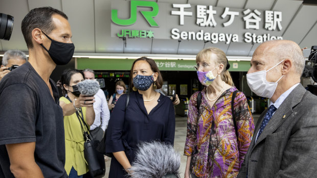 French resident of Japan Vincent Fichot, left, meets EU ambassadors in front of Sendagaya station while on a hunger strike during the Tokyo Olympics.