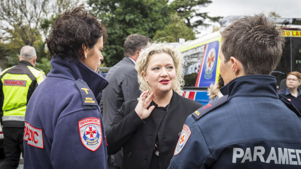 Health Minister Jill Hennessy speak to paramedics  outside Parliament House in May.