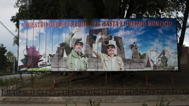 A billboard featuring Fidel and Raul Castro, reading “Our duty is to fight until the last moment,” in Holquin, Cuba, in  2014.