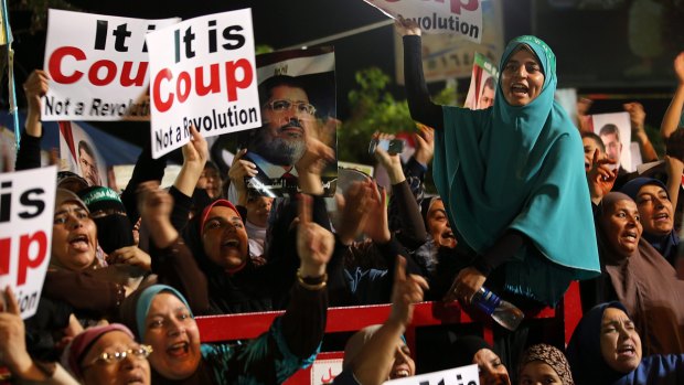 Muslim brotherhood supporters of ousted president Mohamed Morsi attend a protest near Rabaa al-Adawiya mosque in Cairo, Egypt, in 2013.