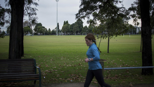 A jogger near the scene where a woman's body was found in Princes Park.