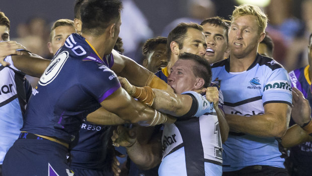 Nelson Asofa-Solomona of the Storm and Paul Gallen of the Sharks get busy during the most penalised game in NRL history.