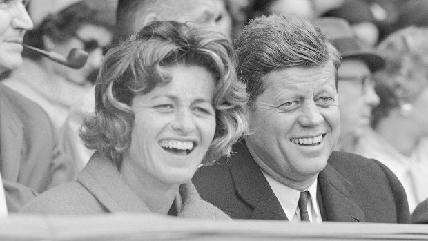 Jean Kennedy Smith and her brother John F. Kennedy watch an opening day baseball game at Griffith Stadium in Washington in 1961.