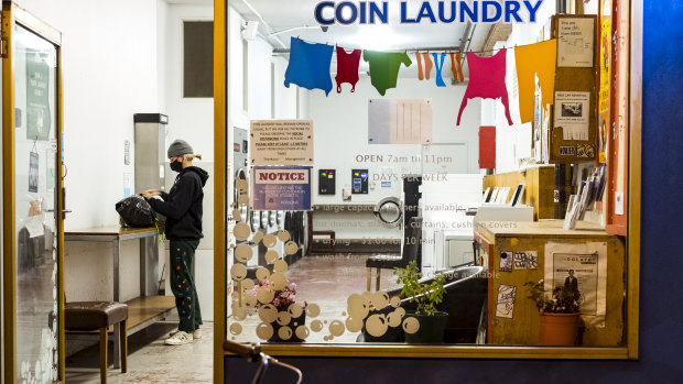 A Melbourne resident takes advantage of the curfew lifting to do some late-night laundry.