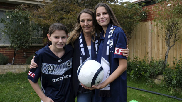 Michelle Candiloro (centre), with her children Marco and Nathalia. Michelle is keen for her children to do activities from Melbourne Victory's remote learning PE course. 