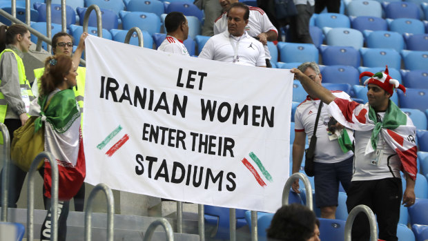 Another banner calls for Iran to allow female supporters to attend local matches.