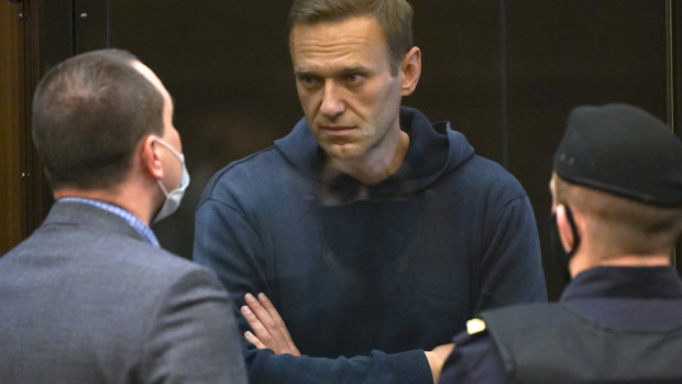 Russian opposition leader Alexei Navalny talks to one of his lawyers in court.