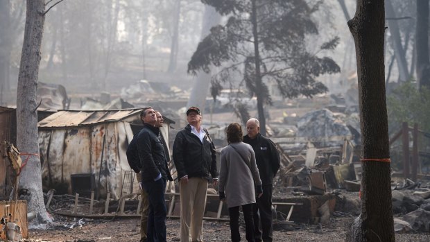Governo-elect Gavin Newsom, FEMA Director Brock Long, President Donald Trump, Paradise mayor Jody Jones and Governor Jerry Brown tour the Skyway Villa Mobile Home and RV Park, during Trump's visit of the Camp Fire in Paradise, California on Saturday.