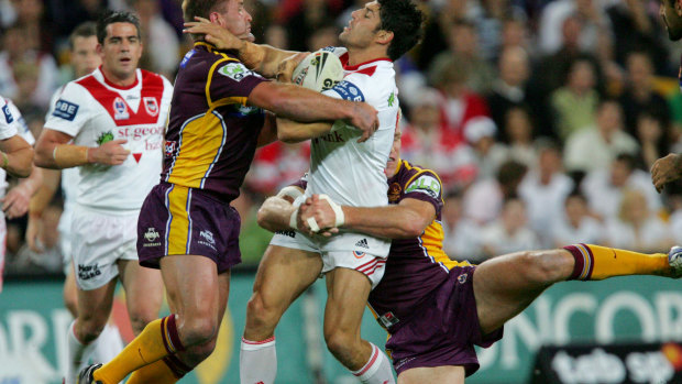 Trent Barrett (centre) is stopped by Shane Webcke and Brad Thorn during the NRL playoffs in 2006.