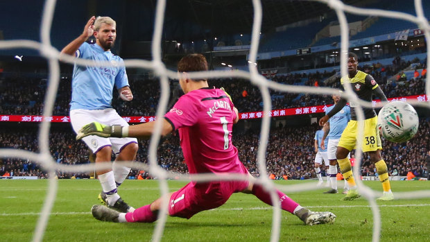 Sergio Aguero scores Manchester City's third goal past Alex McCarthy of Southampton at Etihad Stadium.