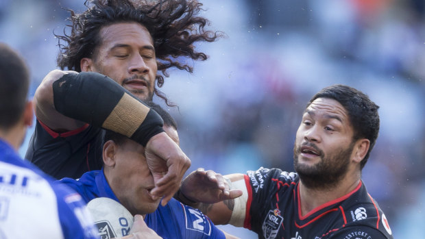 Awkward: Will Hopoate of the Bulldogs is tackled by the Warriors at ANZ Stadium.