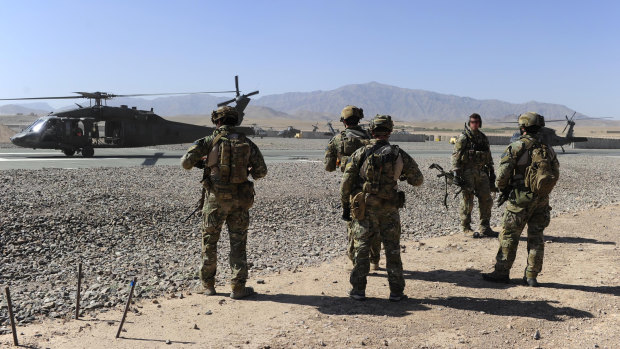 SAS soldiers on duty in Afghanistan move towards a waiting UH-60 Blackhawk helicopter.