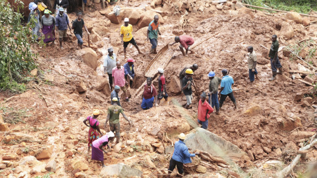 A family dig for their son who was buried in the mud when Cyclone Idai struck in Chimanimani about 600 kilometres south east of Harare, Zimbabwe, on Tuesday.