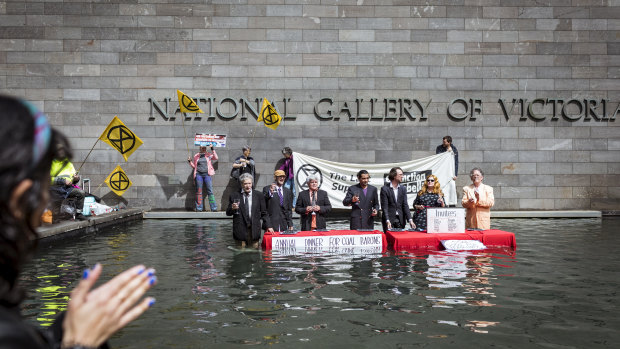 Members of Extinction Rebellion stage a protest in the water feature at the National Gallery of Victoria in Melbourne. 