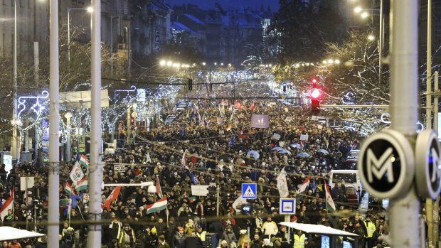 Anti-government demonstrators march under Christmas decorations in the city centre of Budapest on  Sunday.