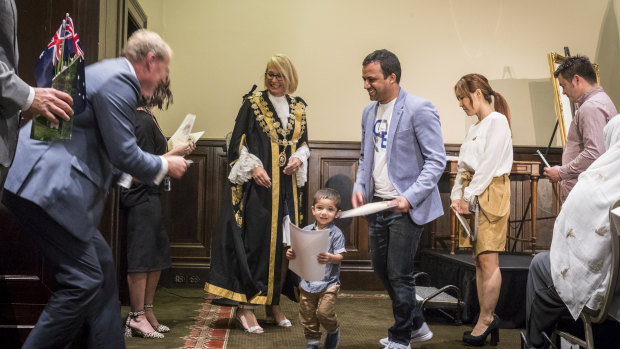 Naga Pandri and his son Srithan (centre) with lord mayor Sally Capp during the citizenship ceremony at Melbourne Town Hall on Saturday.