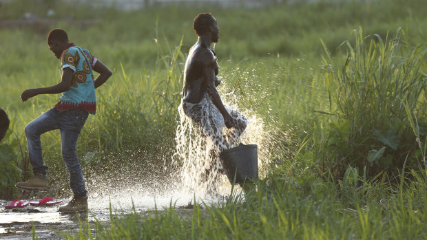 Children play at a watering point in Beira, Mozambique.