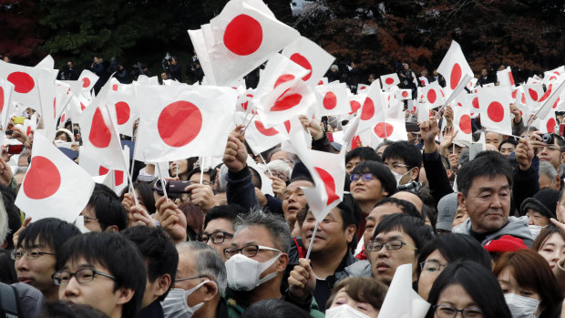 Well-wishers cheer as Japan's Emperor Akihito with his family members appear on the balcony of the Imperial Palace to mark the emperor's 85th birthday in Tokyo on Sunday.