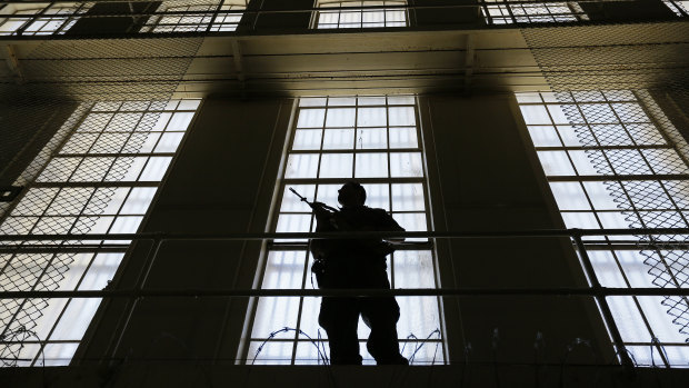 A guard stands watch over the east block of death row at San Quentin State Prison.