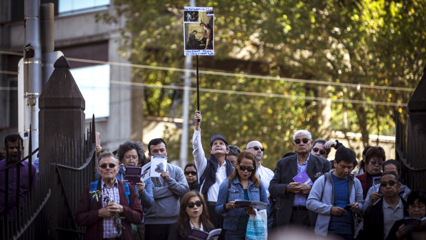 Christians, some with home-made signs, gathered to mark the stations of the cross.