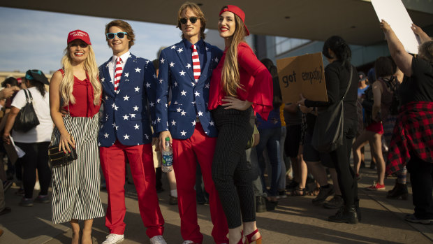 All for out for the USA: young people mingle outside a Trump campaign rally in Minnesota, on Wednesday.