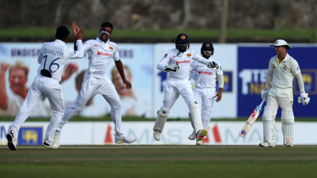 Sri Lankan players celebrate the wicket of David Warner. 